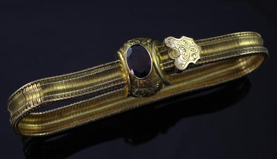 A Victorian gold and garnet snakelink slide action bracelet, gross 18 grams.